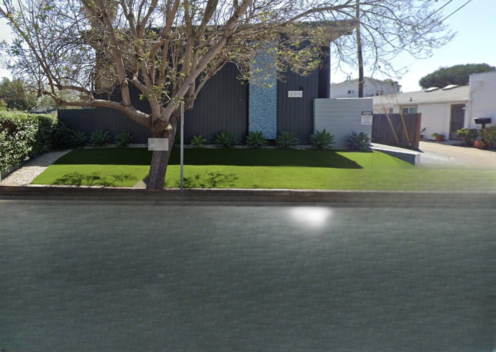 Holiday Plaza Apartments street view with lawn and facade